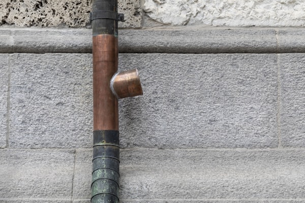 Copper plumbing pipe joint on stone wall